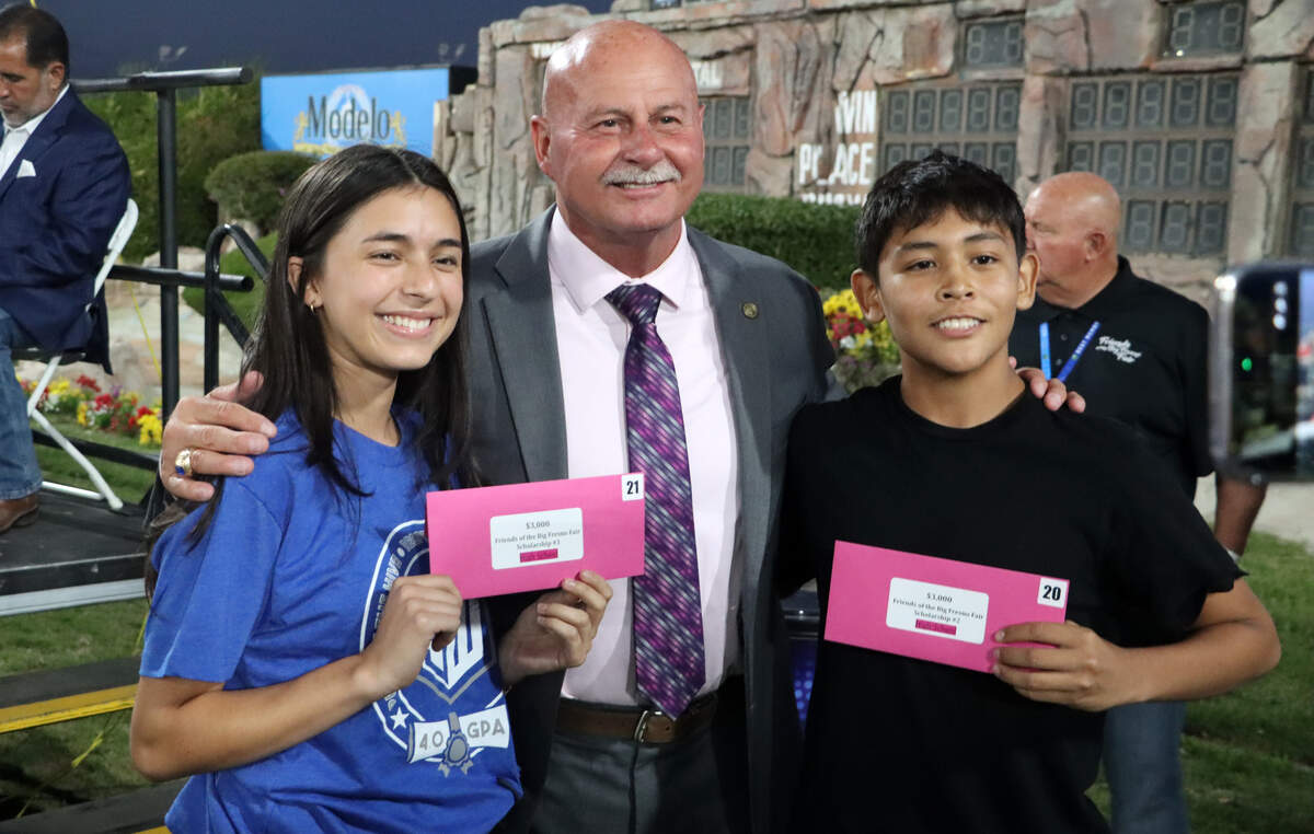 Fresno Mayor Jerry Dyer congratulates two middle school scholarship winners at The Big Fresno Fair's 4.0 and Above program on Sept. 29, 2025.