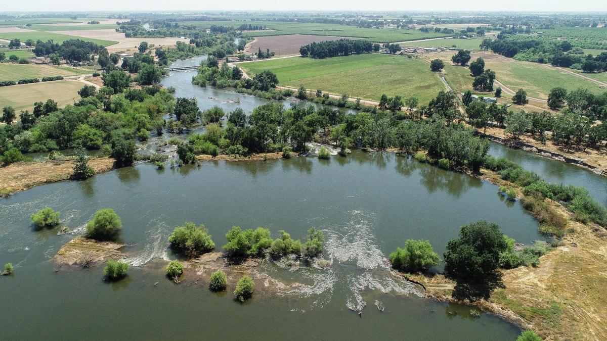 The Kings River stretches out into a ponding area near the Annadale Avenue bridge east of Sanger in eastern Fresno County on Wednesday, May 17, 2023.