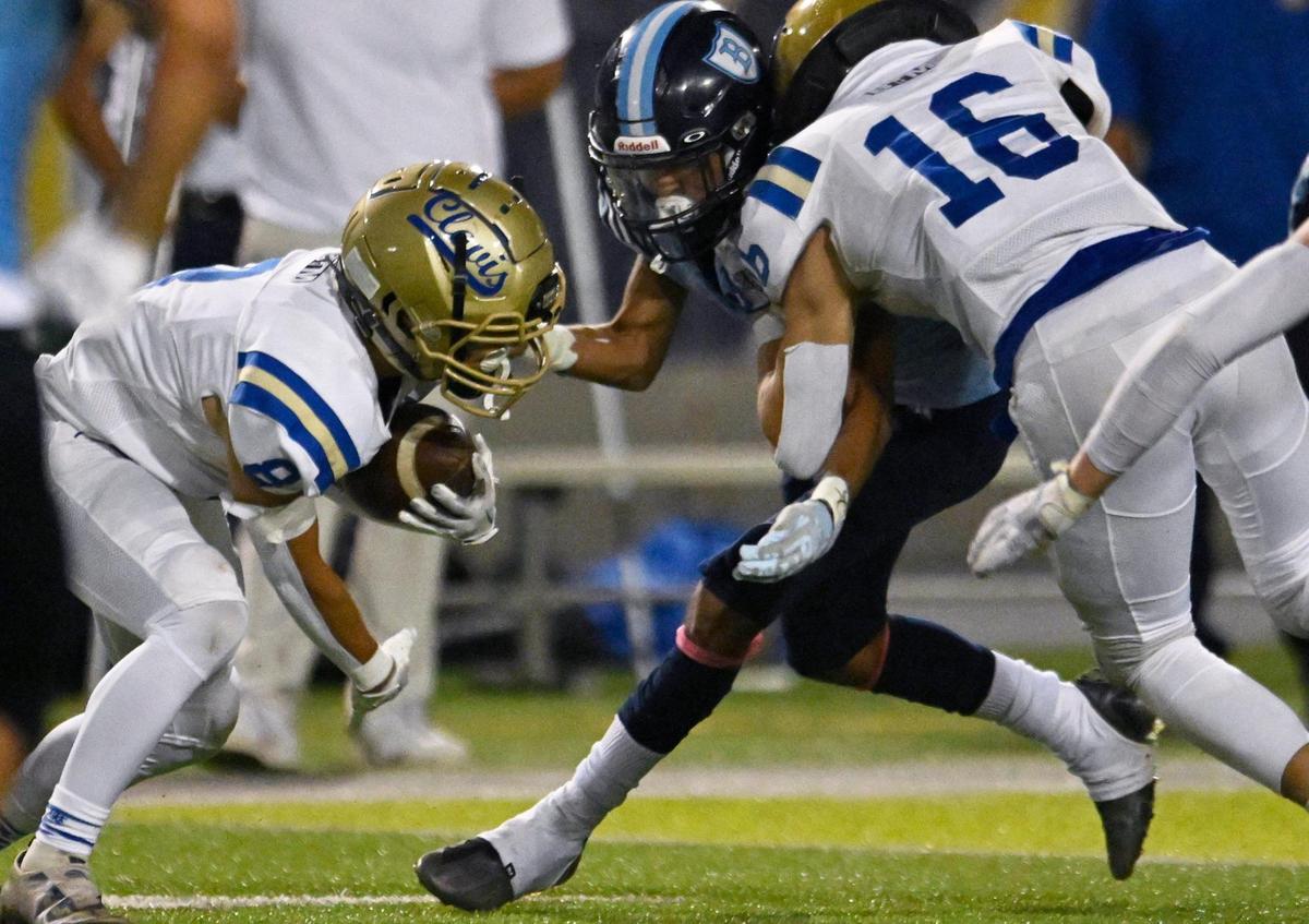 Clovis High’s Noah Luginbill, right, blocks Bullard’s Israel Castaneda, center, for Clovis’ Tyler Marquez, left, Friday, Sept. 15, 2023 in Fresno.