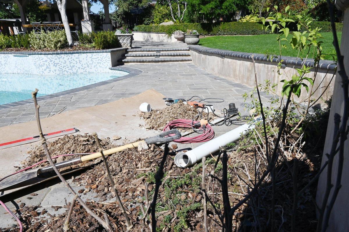 Restaurateur Vatche Moukhtarian said paving stone work, completed by former Sanger mayor and contractor Joshua Mitchell, drained water the wrong way, toward steps seen in the background. Moukhtarian had the work redone, so water would flow to the flower bed in the foreground. He has filed a civil suit against Mitchell.