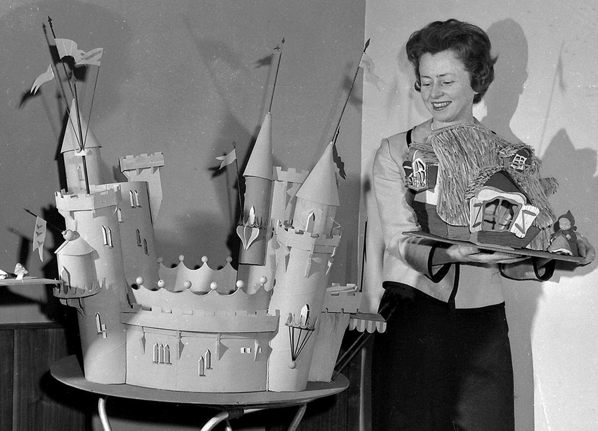 Fresno artist Patricia Hopper, designer of Storyland, shows her models of King ArthurÕs Castle and Red Riding HoodÕs grandmotherÕs house, during a luncheon of Storyland board of directors on Jan. 11, 1961.