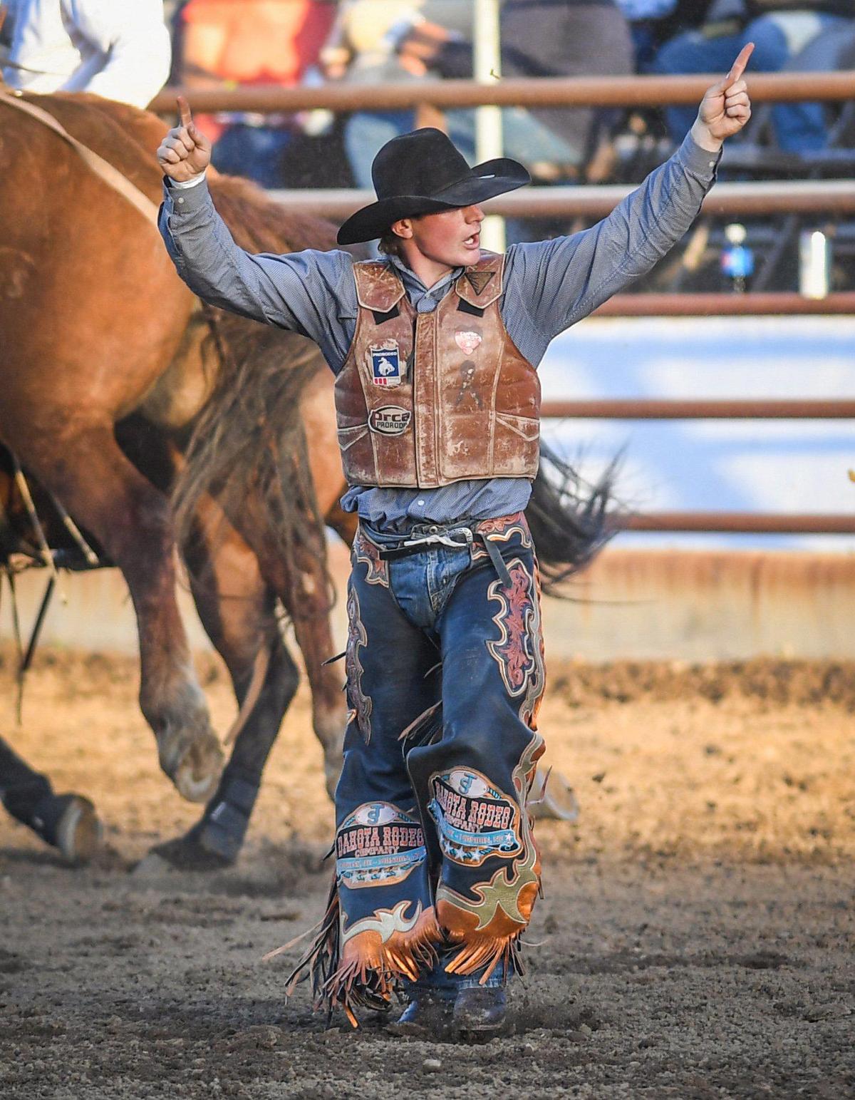 Teagan Smith celebrates his ride on Strawberry Rocket in the saddle bronc riding section of the PRCA event at the Clovis Rodeo on Thursday, April 23, 2021.