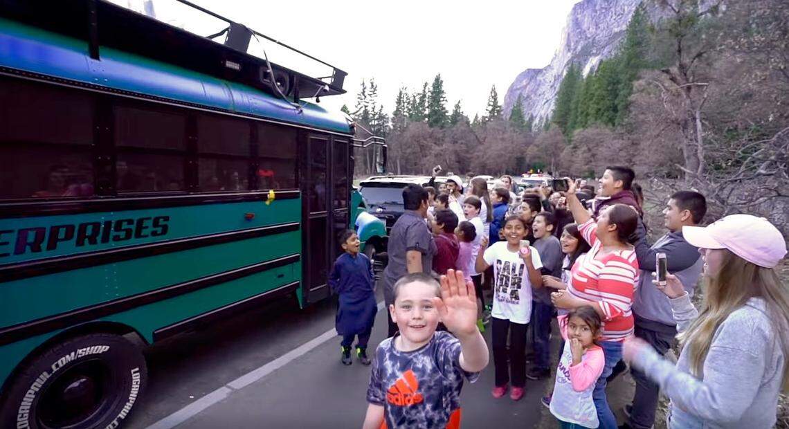 A screenshot from a YouTube video posted by Logan Paul on April 2, 2018 of children gathering outside his 'Cool Bus' in Yosemite National Park over the weekend.