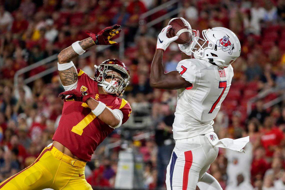Fresno State receiver Derrion Grim, right, hauls in a 34-yard touchdown pass over USC defensive back Chase Williams in the second quarter at the Los Angeles Coliseum on Saturday, Aug. 31, 2019. (Robert Gauthier/Los Angeles Times/TNS)
