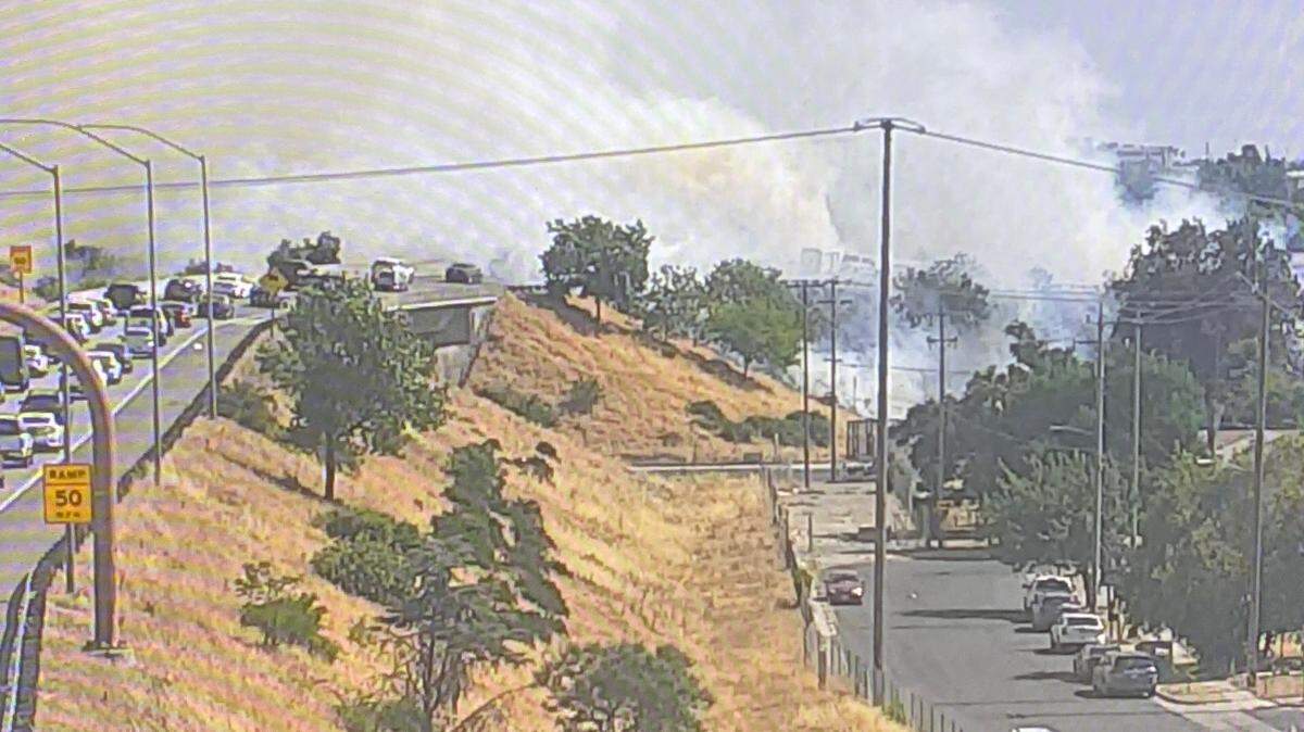 Smoke from highway fire drifts along as motorists try to navigate on Saturday, May 17, 2025.