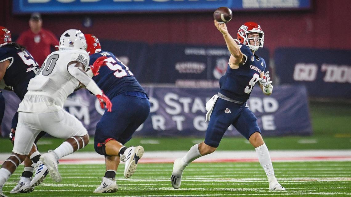 Fresno State quarterback Jake Haener, right throws after scrambling out of the pocket during their game against UNLV at Bulldog Stadium on Friday, Sept. 24, 2021.