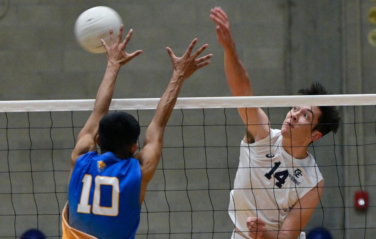 Clovis East’s Mason Stokes, right, with Clovis High’s Aiden Insyarath, left, in the Central Section Division I volleyball championship Thursday, May 11, 2023 in Clovis.