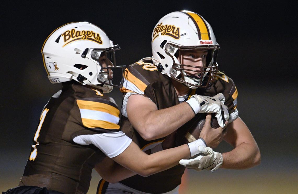 Golden West quarterback Jayden Najera, left, hands off to Case Anders , right, in the D2 semifinal championship game against Central Valley Christian Friday night, Nov. 22, 2024 in Visalia.