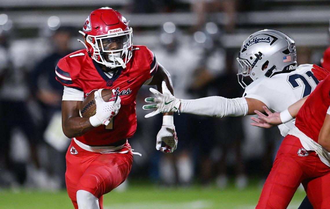 Clovis East’s Tristan Kircher, right, reaches out for Sanger’s Bryson Baker, left, in a non-conference matchup Friday, Sept. 6, 2024 in Sanger. Final score, Clovis East 56, Sanger, 3.