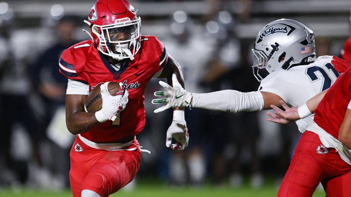 Clovis East’s Tristan Kircher, right, reaches out for Sanger’s Bryson Baker, left, in a non-conference matchup Friday, Sept. 6, 2024 in Sanger. Final score, Clovis East 56, Sanger, 3.