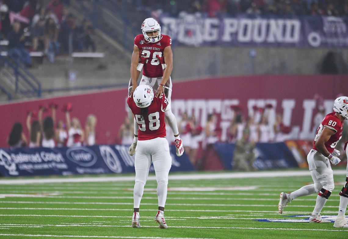Fresno State’s David Perales, bottom, hoists kicker Cesar Silva in celebration after Silva’s 51-yard field goal against New Mexico in the last home game for the Bulldogs Saturday, Nov. 13, 2021 in Fresno. The Bulldogs led 24-0 at halftime.