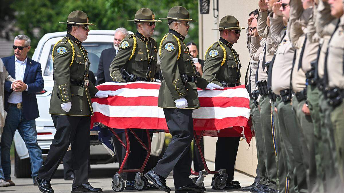 Tulare County Sheriff’s deputies transport the body of Fallen TCSO Deputy Randy Hoppert is carried into Salsar and Dillard Funeral Home in Visalia following a processional of law enforcement vehicles who escorted Hoppert from the Tulare County Coroner’s Office in Tulare as community members paid respects along the route on Monday, April 13, 2026.