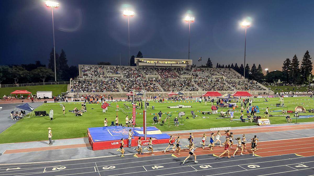 Athletes compete under the lights at Veterans Memorial Stadium in Clovis during the CIF state track and field championships on Saturday.