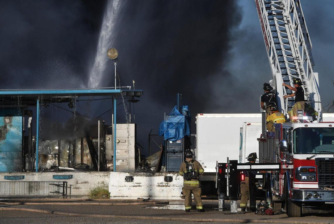 Fresno Fire crews with help from Fresno County, attacked a warehouse and adjacent grass fire at a warehouse on N. Thorne Ave, just north of W. Nielsen Ave near downtown, June 26, 2021 in Fresno.