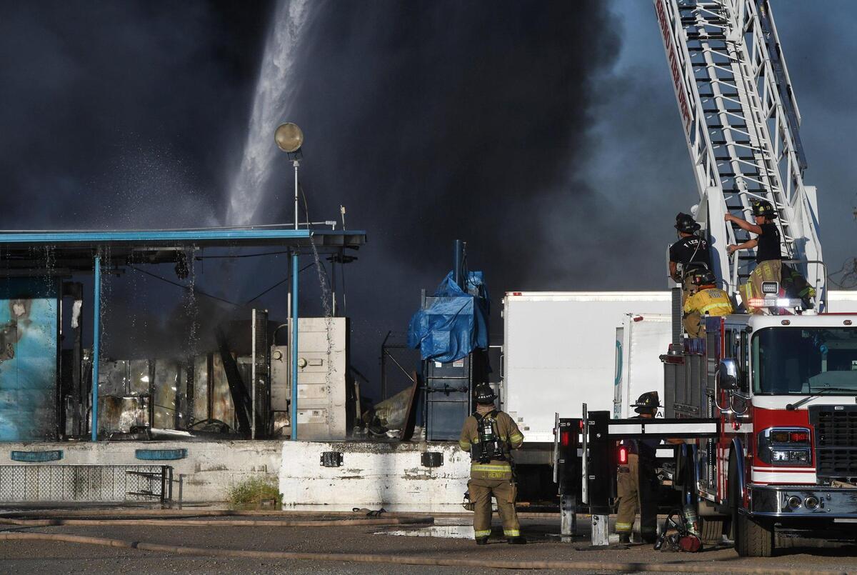 Fresno Fire crews, with help from Fresno County, attacked a warehouse and adjacent grass fire on North Thorne Avenue, just north of West Nielsen Avenue, on Saturday, June 26, 2021.