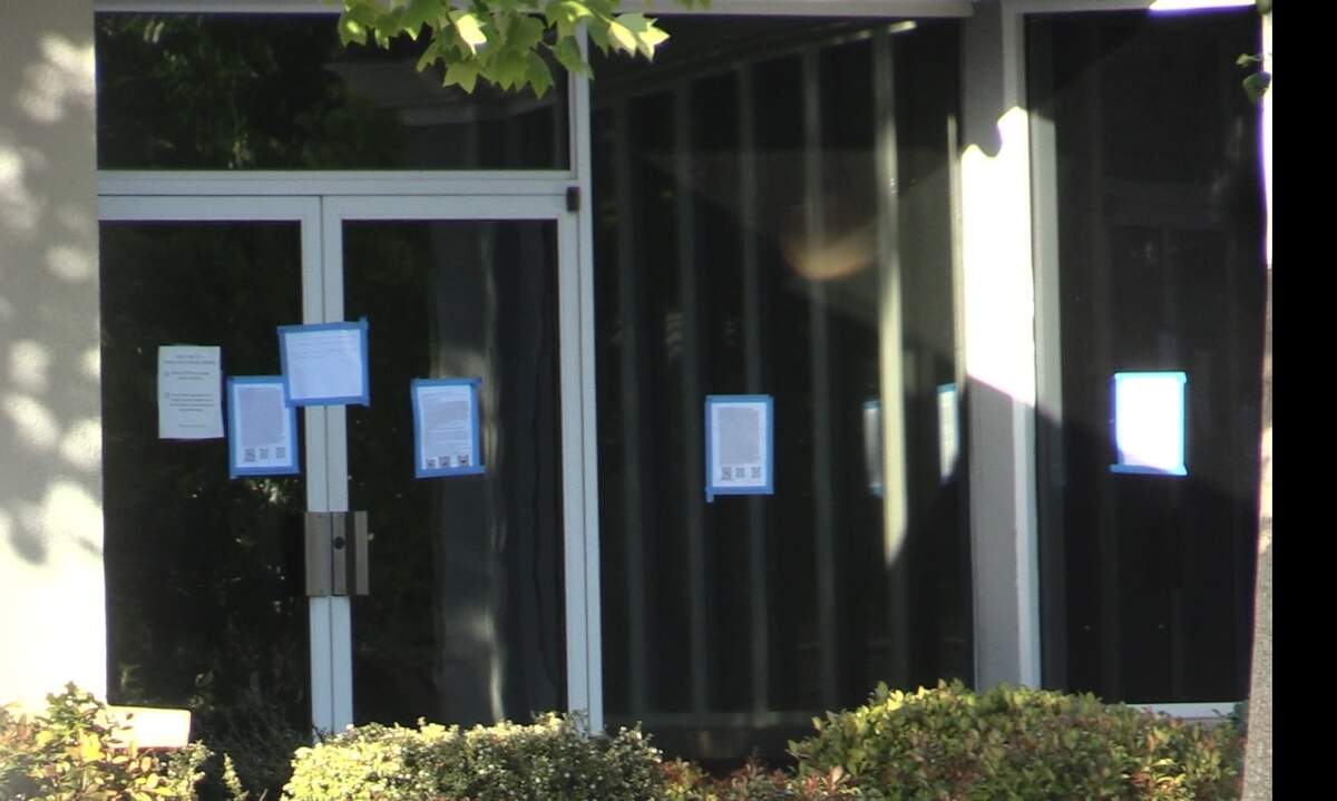 Fliers shown here that is heavily taped on a few of the Temple Beth Israel windows and glass door that contains religious content, along with a QR code on Thursday, May 2, 2024.