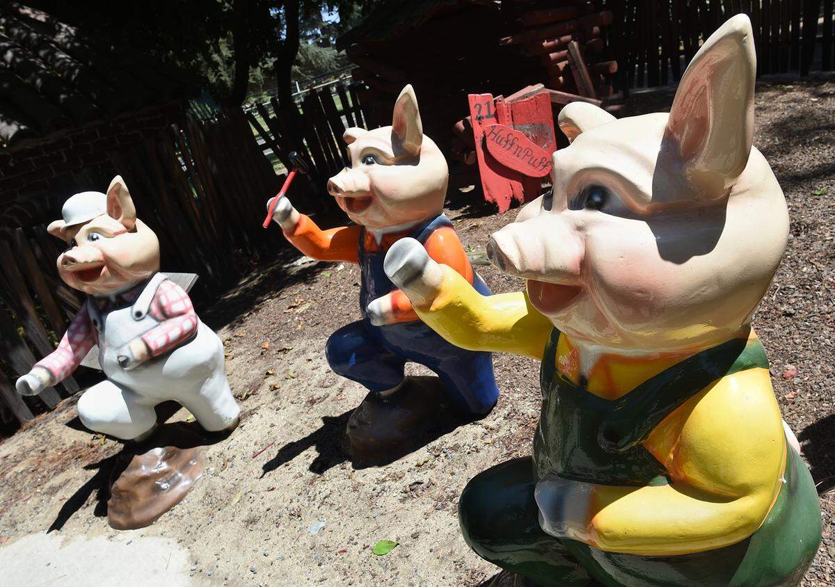 Fiberglass figures of The Three Little Pigs, created by Patricia Hopper, bright and chipper after restoration.