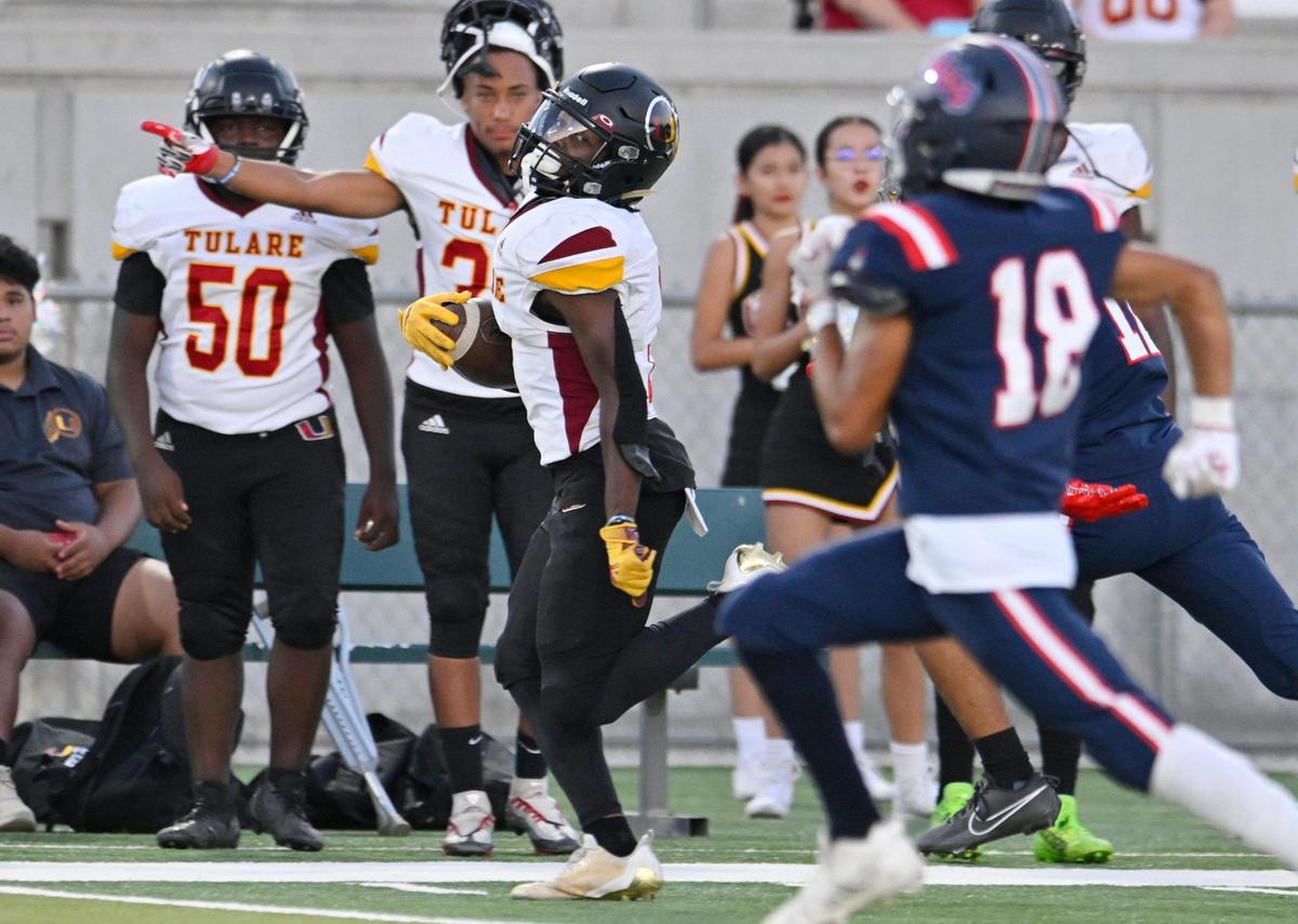 Tulare Union’s Brayden Stevenson, left, races Garza’s defense along the sidelines Thursday, Sept. 7, 2023 in Fresno. Tulare led Garza 35-28 at halftime.