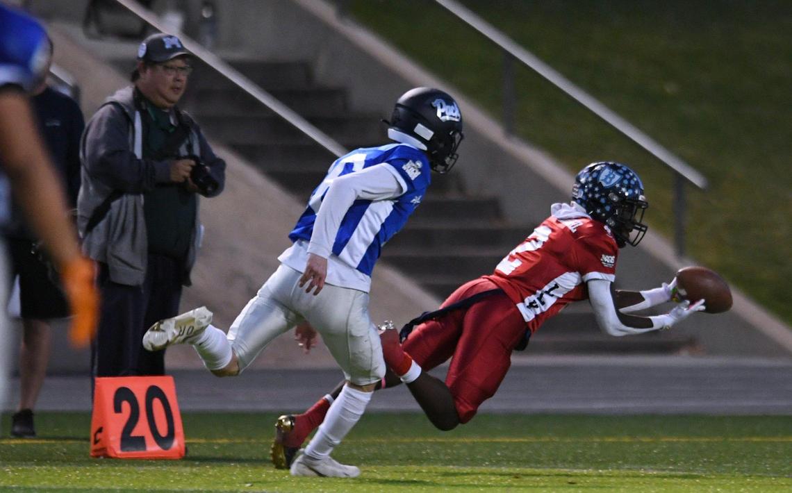 Bullard’s Jalyn Utendahl, right, makes a catch covered by Clovis East’s Levi Demmon, left, at the City/County All-Star football game held at McLane High’s stadium Friday night, June 17, 2022 in Fresno. The game ended 21-21.
