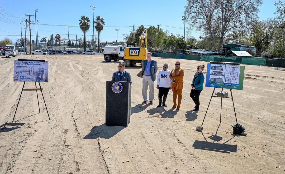 Fresno Councilmember Miguel Arias, at lectern, is joined by representatives from Self-Help Enterprises, the Fresno Redevelopment Successor Agency, and the Golden West Side Planning Committee, announces the beginning of construction of a single-family affordable housing project on an empty lot near Edison High School at Walnut and Florence avenues in west Fresno on April 4, 2023.