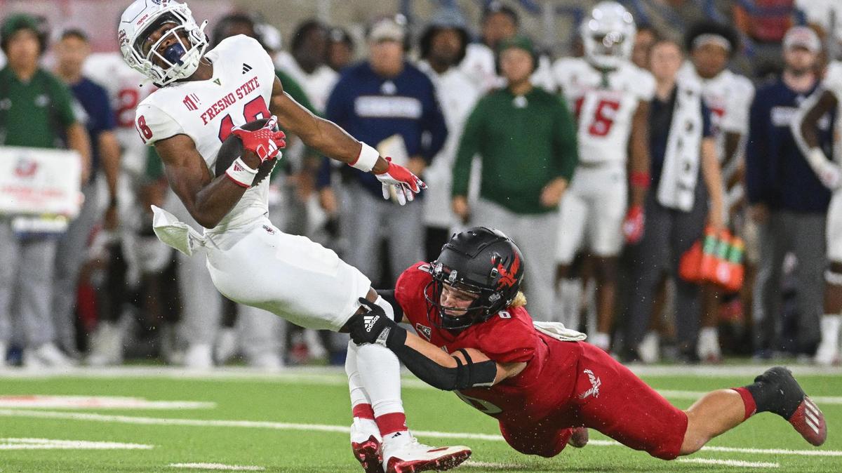 Fresno State wideout Jalen Moss tries to spin away from Eastern Washington’s Jaren Banks after a catch in the second half of the Bulldogs’ 34-31 double-overtime victory at Valley Children’s Stadium on Saturday, Sept. 9, 2023.