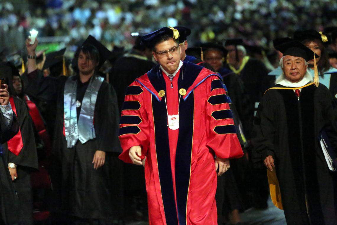 Scenes from the 103rd commencement ceremony for Fresno State University in 2014. About 1,300 graduates took part in the ceremony in front of 10,235 specatators. 4,675 bachelor's, 890 master's and 69 doctorates. 37 students achieved perfect 4.0 GPAs. Dr. Joseph I. Castro, Fresno State president, walks during his first graduation ceremony at the university.