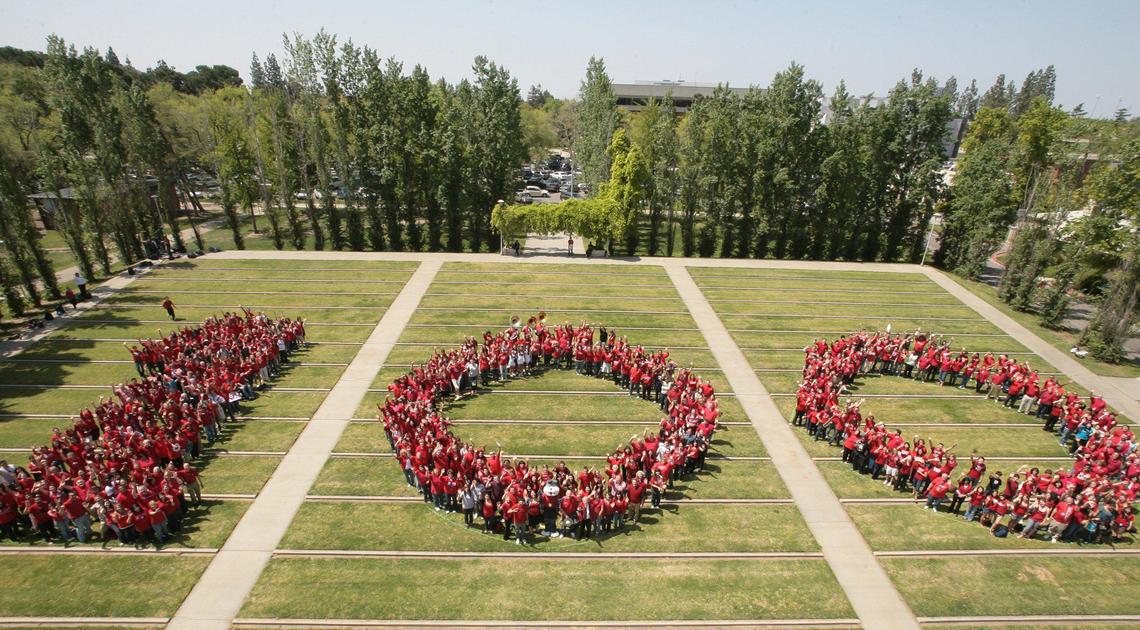 In 2010, hundreds of Fresno State students, alumni and staff gather to form “100” at the university’s amphitheater as part of the kickoff for the university centennial celebration.