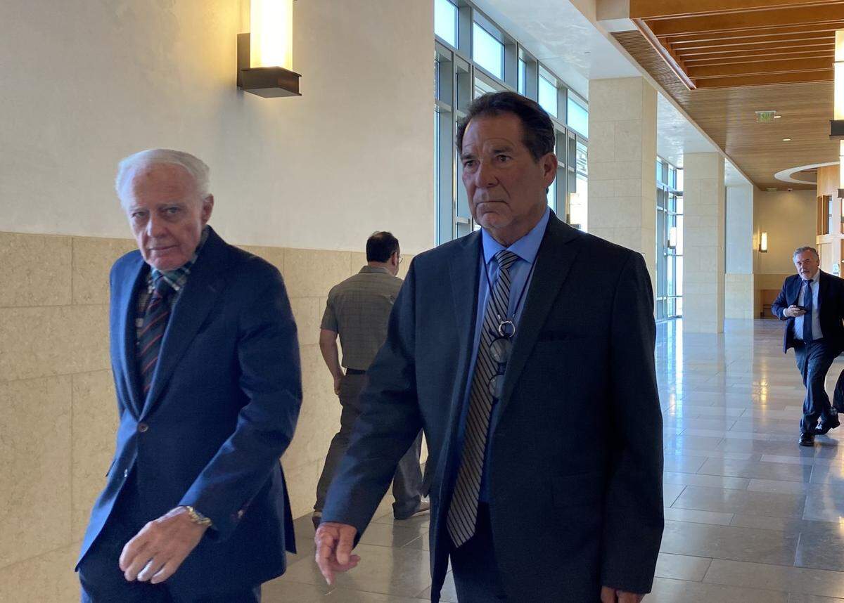 Dennis Falaschi, 78, right, walks through a hallway of the Eastern District of California in Fresno on Monday, Sept. 30, 2024, before his sentencing for stealing water. He was accompanied by Robert Wanger, left, a retired Fresno County judge and one of Falaschi’s attorneys.