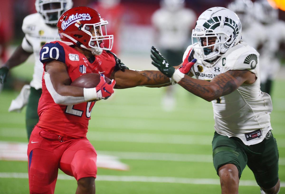 Fresno State’s Ronnie Rivers, left, fends off Colorado State’s Jamal Hicks, right, in the Rams’ 41-31 victory over the Bulldogs Saturday, Oct. 26, 2019 in Fresno. Rivers rushed for a season-high 146 yards in the loss.