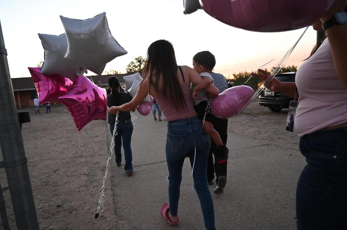 Family and friends attend a vigil for Yanelly Solorio Rivera, 18, and her 3-week-old girl, Celine Solorio Rivera on Tuesday evening, Sept. 27, 2022 south of Fresno. The two died after being shot at their rural home Saturday. Police are still searching for the killer.