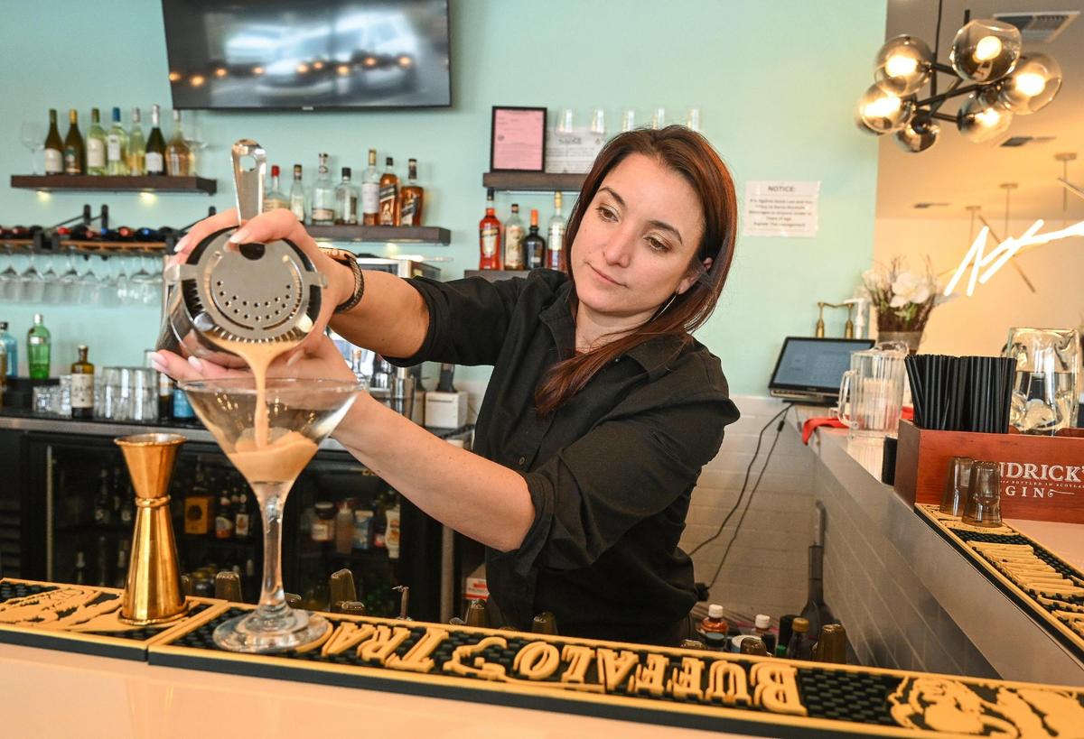 Bartender Gina Baptista pours a Genesis espresso martini while working the bar at Genesis Bistro & 8028 Salon. The bistro features several unique craft cocktails on its menu.