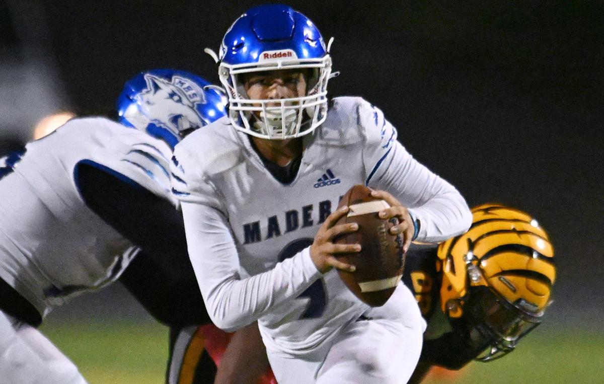 Madera quarterback Joel Arellano scrambles to pass against Edison Friday, Oct. 20, 2023 in Fresno.