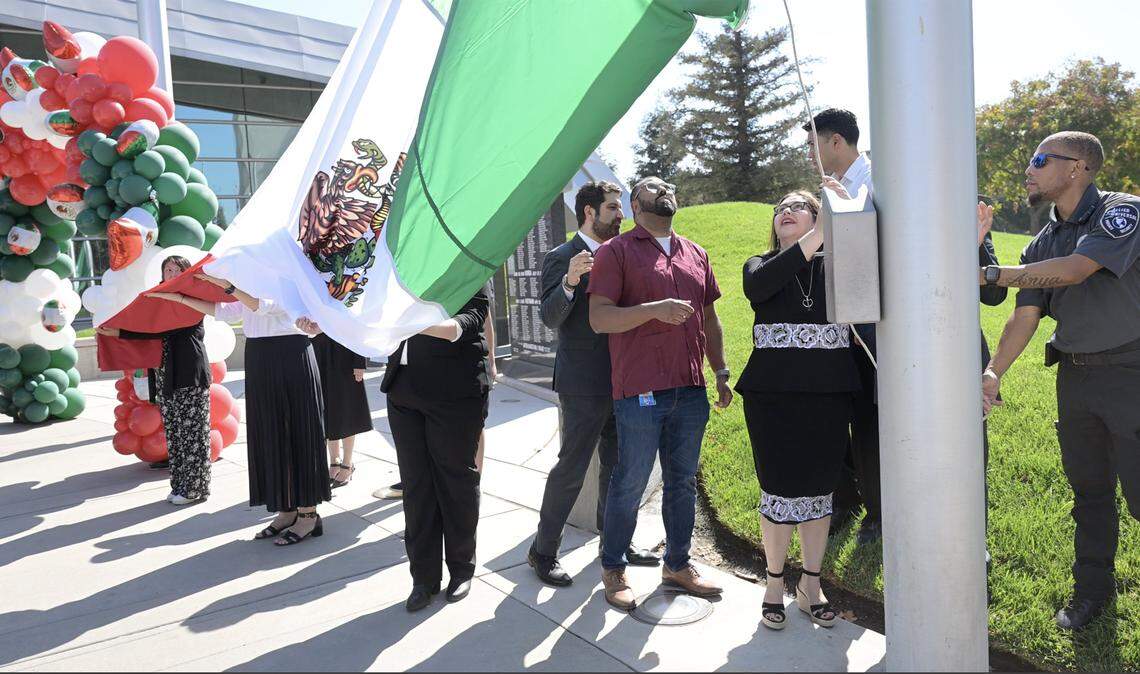 The new Mexican Consul Irma de Los Ángeles Pimentel Portilla pulls the Mexican flag up the flag pole in front of Fresno City Hall Tuesday, Sept. 16, 2025 in downtown Fresno.