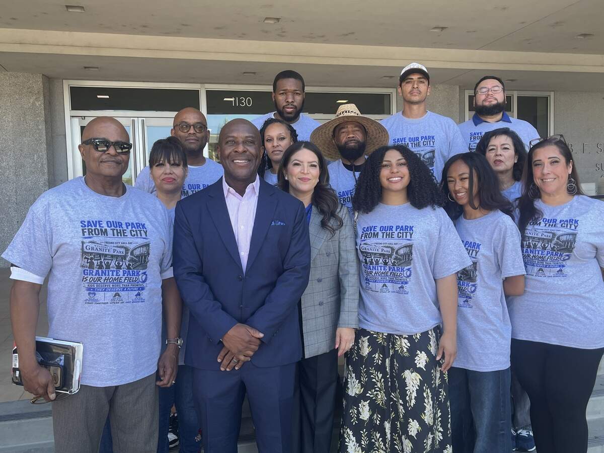 CVCSF President Terance Frazier, center in suit, and wife, Assemblymember Esmeralda Soria, D-Fresno, right of Frazier, pose with supporters after a court ruling that the Granite Park Sports Complex will return to the city.
