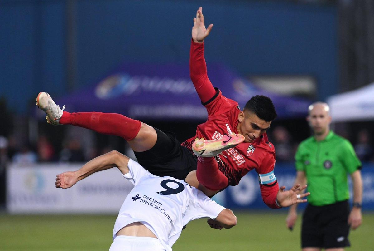 Central Valley Fuego FC’s Jordan Chavez, top, collides with Greenville Triumph SC’s Jake Keegan, bottom in the Fuego’s home opener Saturday night, May 7, 2022 in Fresno.