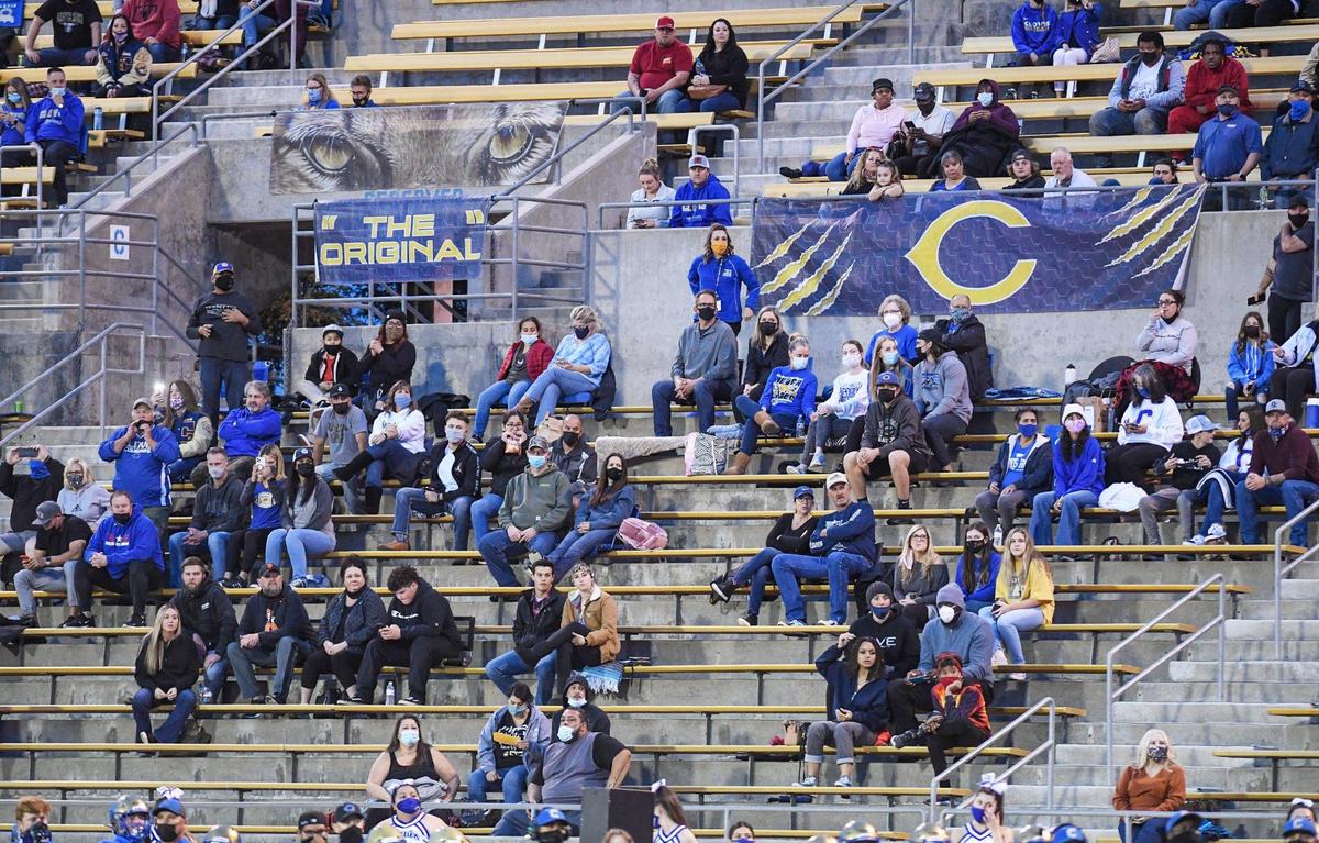 A smaller crowd of mostly just family members are spaced out in the stands during the first game of 2021with Central taking on Clovis at Lamonica Stadium in Clovis on Thursday, March 18, 2021.