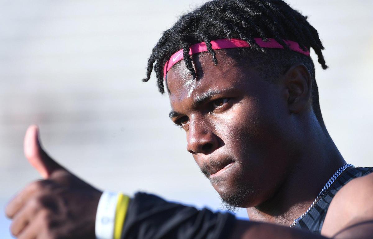 Clovis High’s Nathan Johnson, who took first place in the 100, gives a thumbs up at the Central Section Masters held at Buchanan High School Saturday, May 21, 2022 in Clovis.