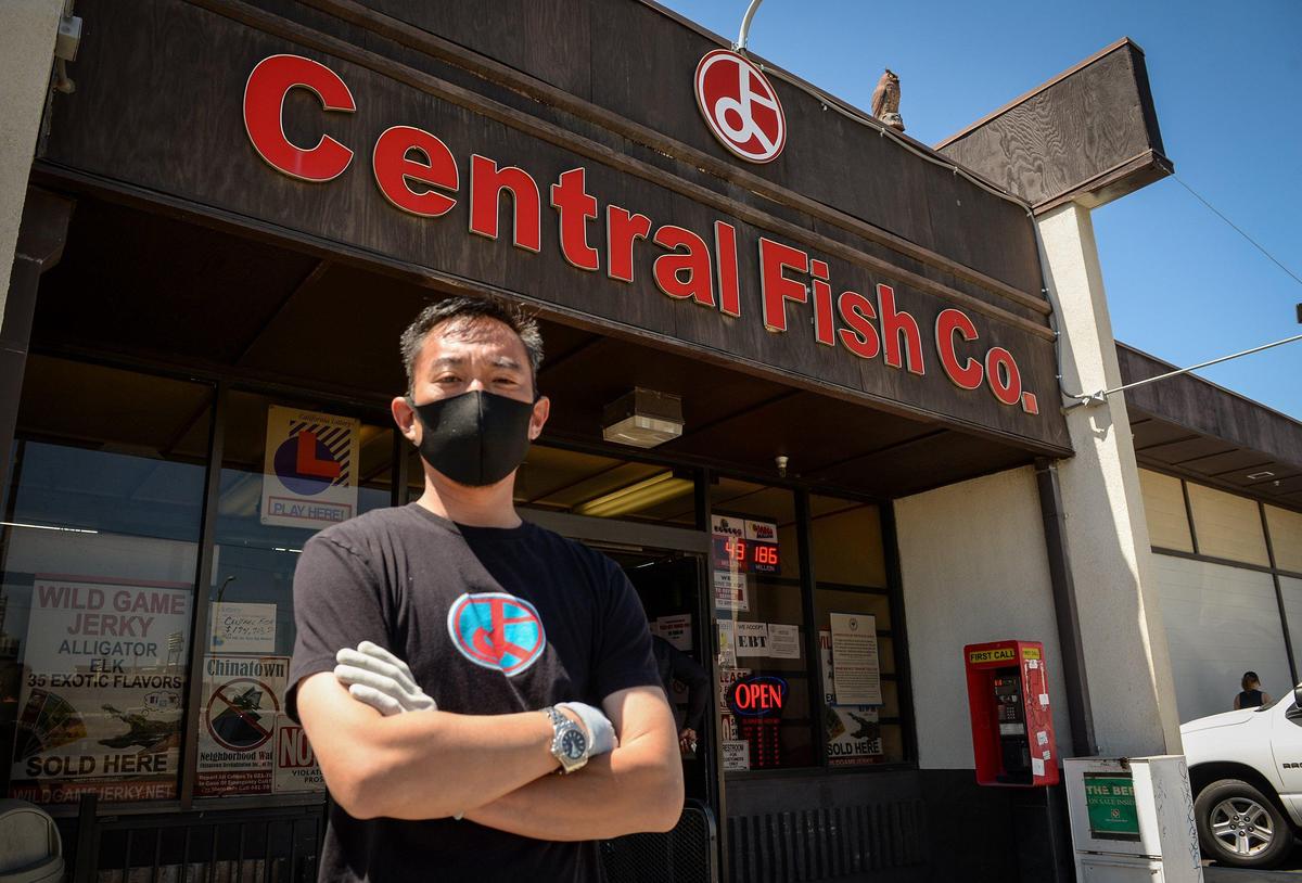 Central Fish Co. owner Morgan Doizaki stands outside the market and restaurant on Tuesday, April 28, 2020. Coronavirus closure orders have affected the business, prompting the owners to get creative to keep afloat during the economic downturn, Doizaki says, but the virus is one more strike to the Chinatown business area already hit hard by shut down roadways due to high-speed rail construction as well as the ongoing homeless problem.