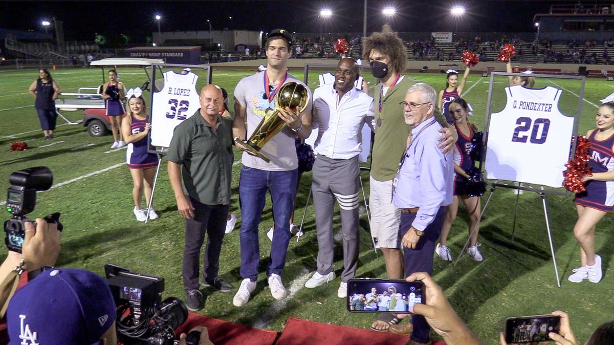 Fresno Mayor Jerry Dyer, from left, stands with NBA player Brook Lopez, former NBA player Quincy Pondexter, NBA player and Brook’s brother Robin Lopez, and San Joaquin Memorial High School President Michael Burke, as they are photographed following a school jersey retirement ceremony for the Lopezes and Pondexter who were basketball stars at the school, on Friday, Sept. 17, 2021.