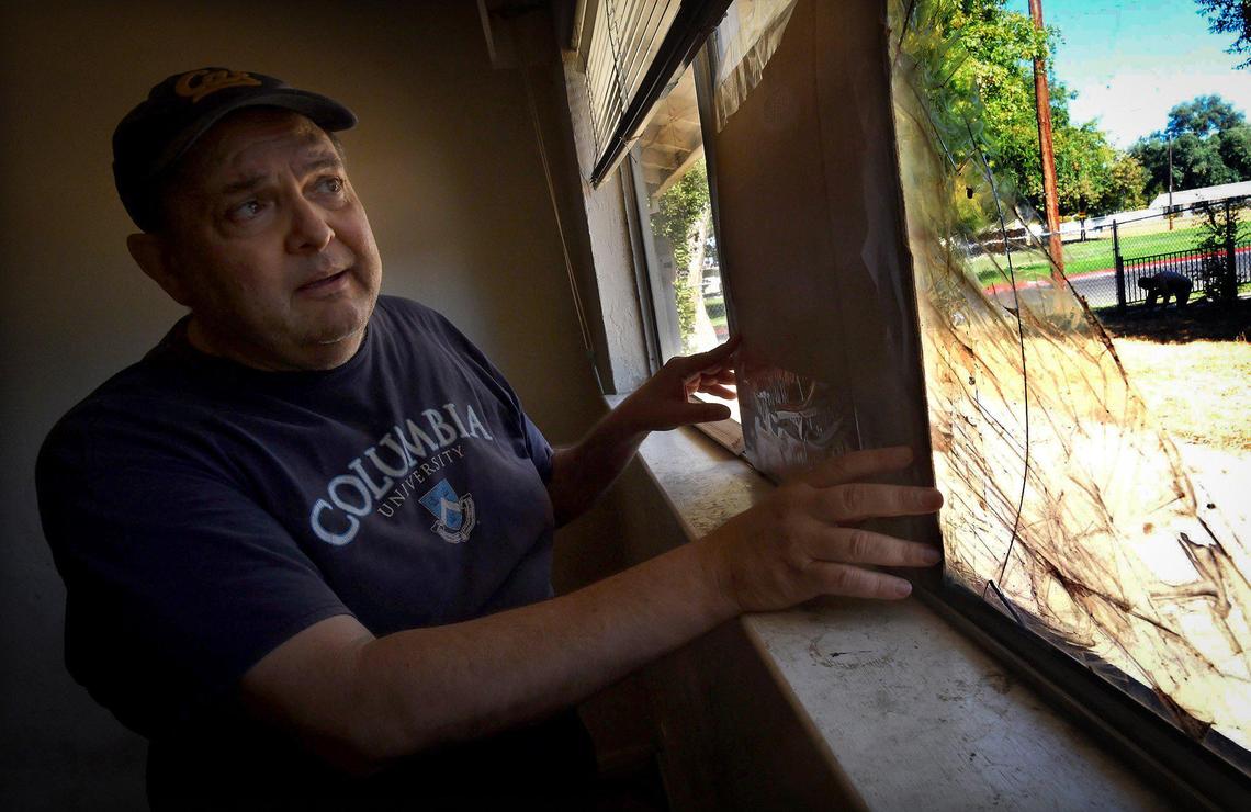 Ed Lanfranco, a Southeast Fresno landlord, holds a piece of cardboard partially covering a broken window as he surveys damage to his rental, abandoned by the tenant and leaving him with $7,800 unpaid rent, and at least, he says $20,000 in damages. The tenant refused to fill out the emergency rental assistance forms and he couldn’t get the money without her participation.