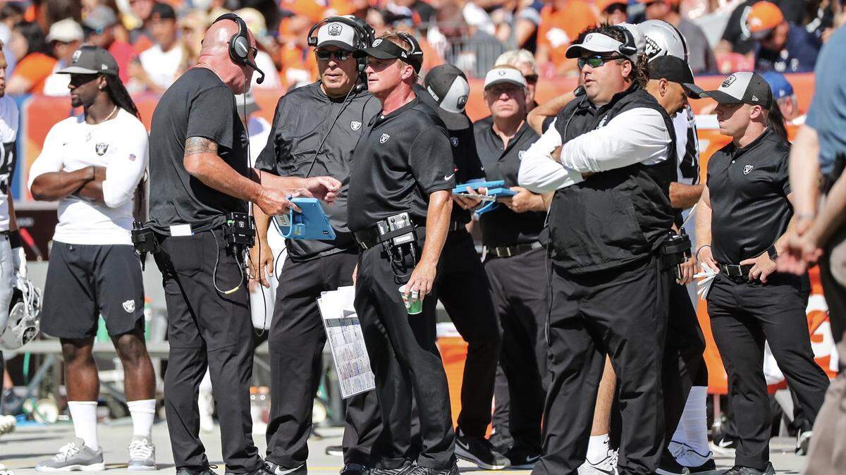 Oakland Raiders coach Jon Gruden talks to offensive line coach Tom Cable during the Raiders/Denver Broncos game on Sunday, Sept. 16, 2018. The Raiders fell 20-19.
