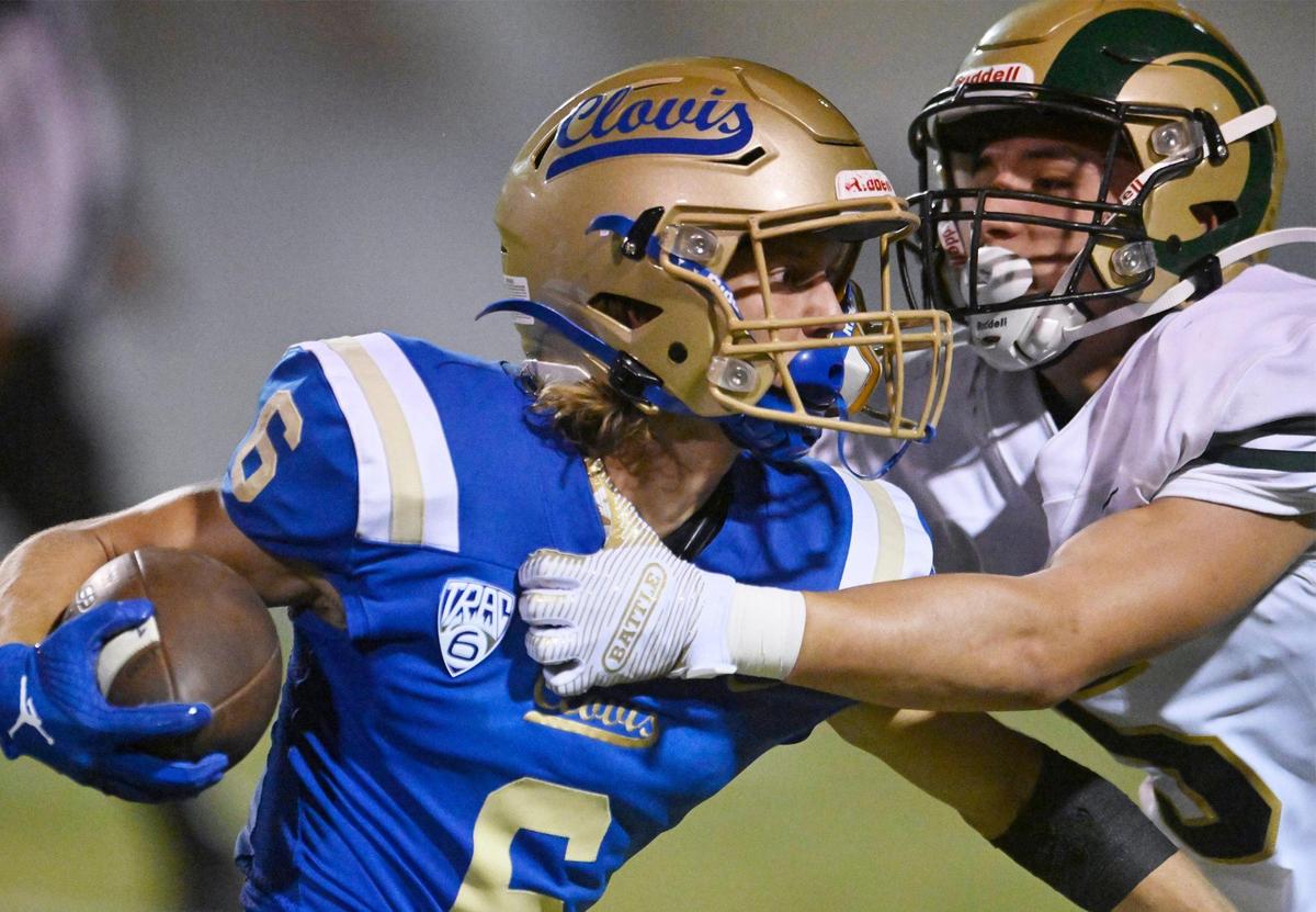 Clovis High’s Tyler Cheney, left, tries to cut back on a carry against Garces High’s Austyn Hernandez, right, Thursday, Aug. 17, 2023 in Clovis.