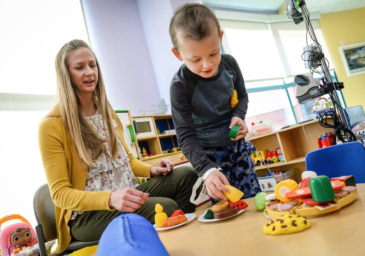 Child Life specialist Sarah Freer works with chemotherapy patient Wyatt Vannoy, 6, of Visalia, in the Chid Life Center at Valley Children’s Hospital in Madera on Friday, Feb. 14, 2020.
