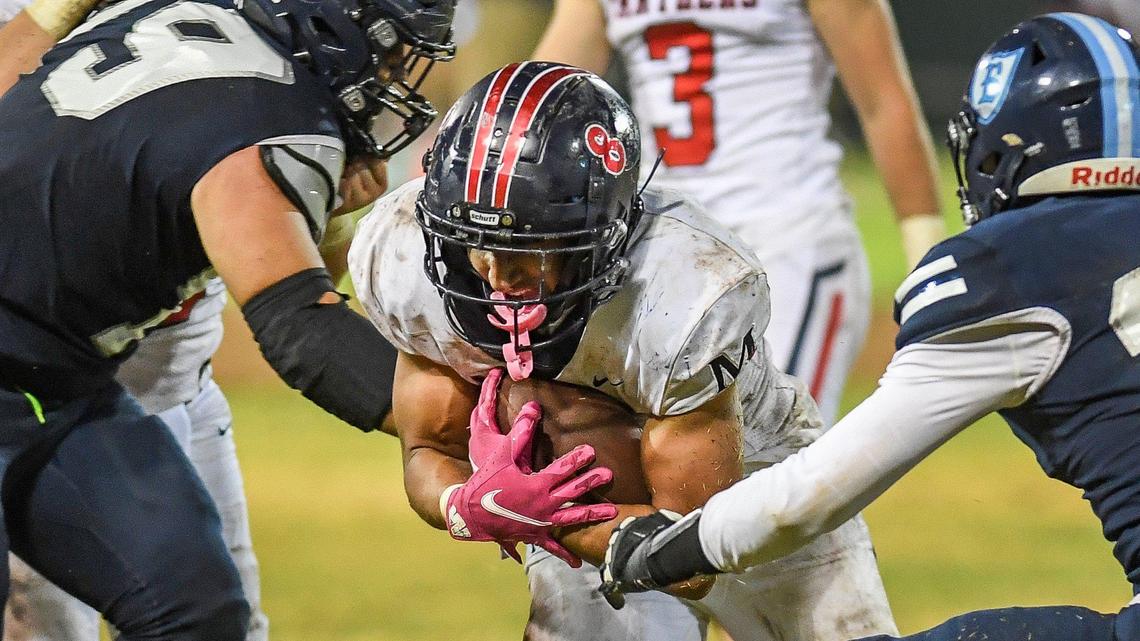 San Joaquin Memorial’s Brandon Ramirez tries to break through the Bullard defense on a run up the middle during their game at Chukchansi Park on Friday, Oct. 8, 2021.