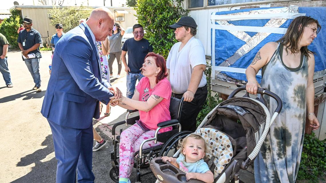 Fresno Mayor Jerry Dyer meets with Trails End Mobile Home Park resident Heidi Phipps and her family at the park on Friday, March 25, 2022. Dyer and Fresno City Councilmember Garry Bredefeld spoke to residents to discuss concerns about the possible sale of the park to Harmony Communities on Friday, March 25, 2022.