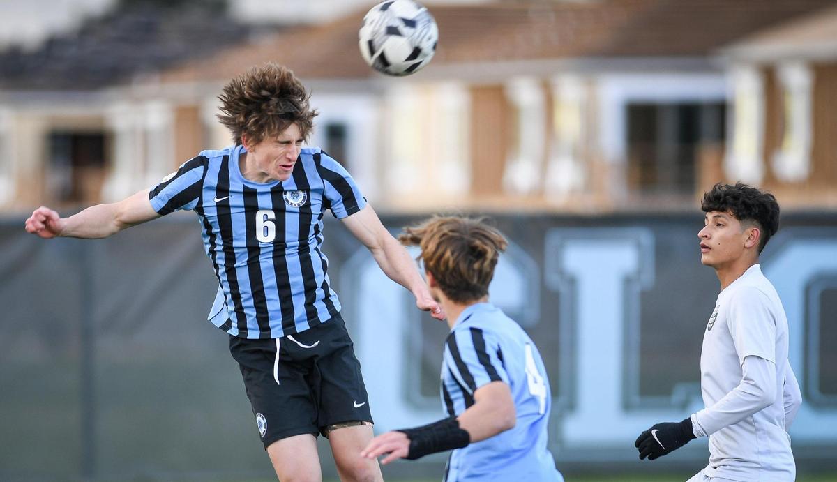 Clovis North’s Steven Mohr, left, heads the ball upfield during their match against Reedley at Clovis North on Tuesday, Feb. 22, 2022.