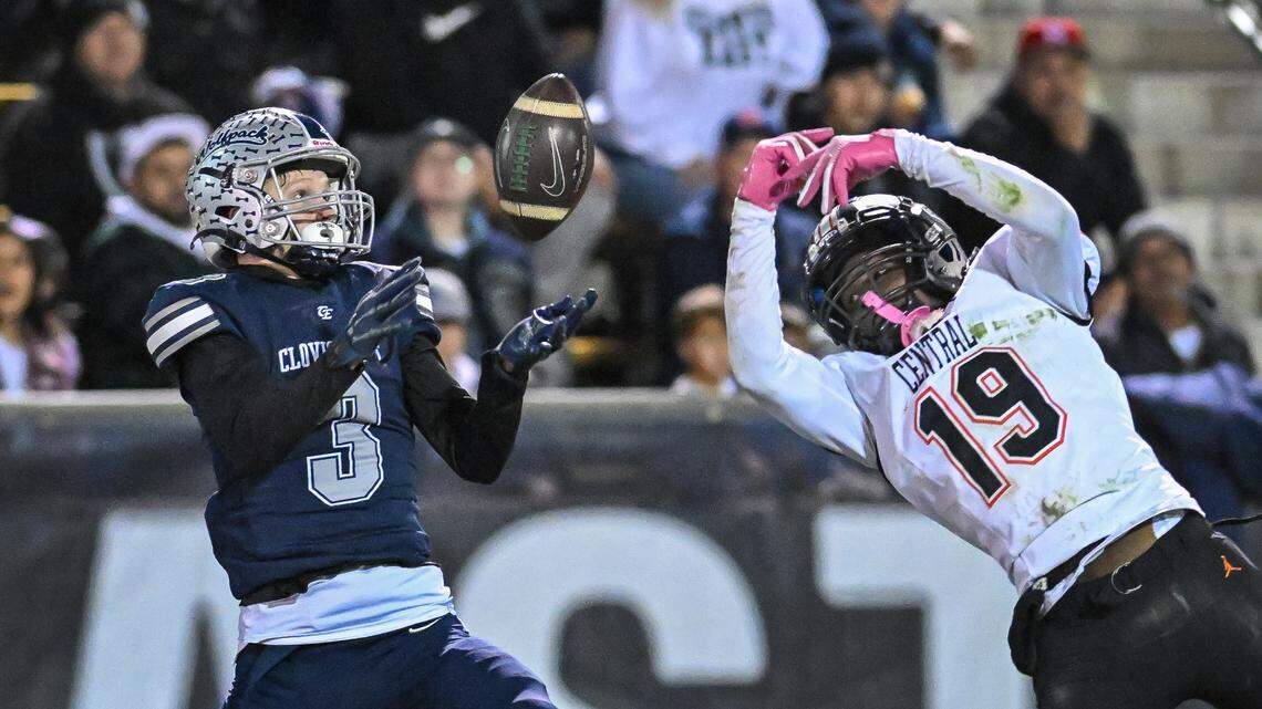 A pass to Clovis East’s Blake Mathieu, left, is broken up by Central’s Jareal Albert during their Central Section Division 1-AA football championship game at Lamonica Stadium on Friday, Nov. 22, 2024.