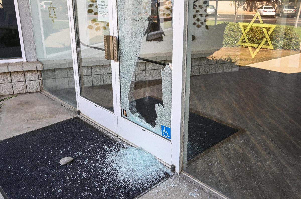 Broken glass and a nearby rock are shown on the doors of Temple Beth Israel where Fresno police are investigating a potential hate crime on Tuesday, Oct. 10, 2023.