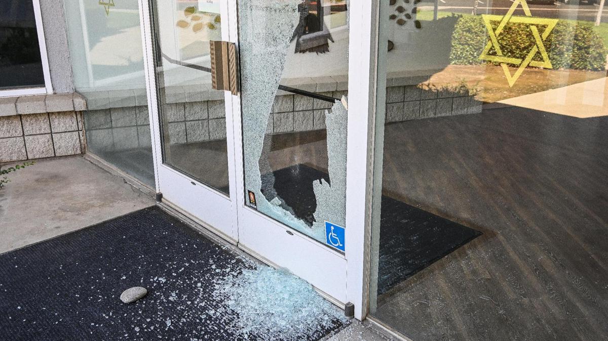 Broken glass and a nearby rock are shown on the doors of Temple Beth Israel where Fresno police are investigating a potential hate crime on Tuesday, Oct. 10, 2023.