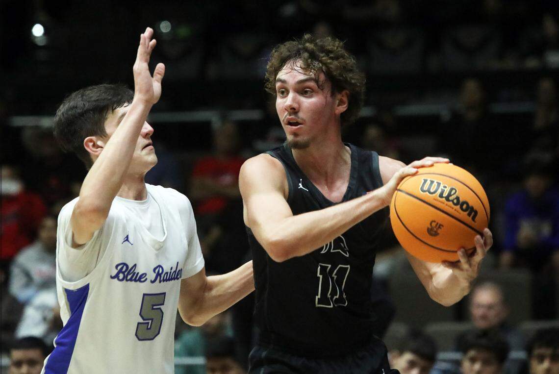 Strathmore High center Canyon Johnson encounters the defense of Caruthers High’s Timothy Hurt during the CIF Central Section Division VI championship game at Selland Arena. Caruthers won, 37-28.